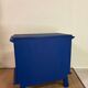 Small vintage upcycled side table in midnight blue and raw wood, with a rose-shaped door.