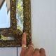 Miroir à parecloses en bois doré et métal repoussé