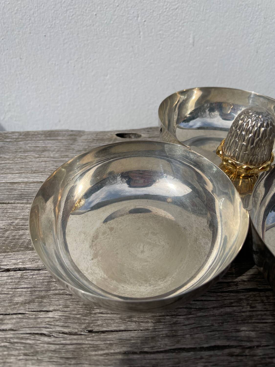 Silver-plated metal dish topped with an acorn
