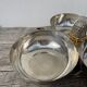 Silver-plated metal dish topped with an acorn