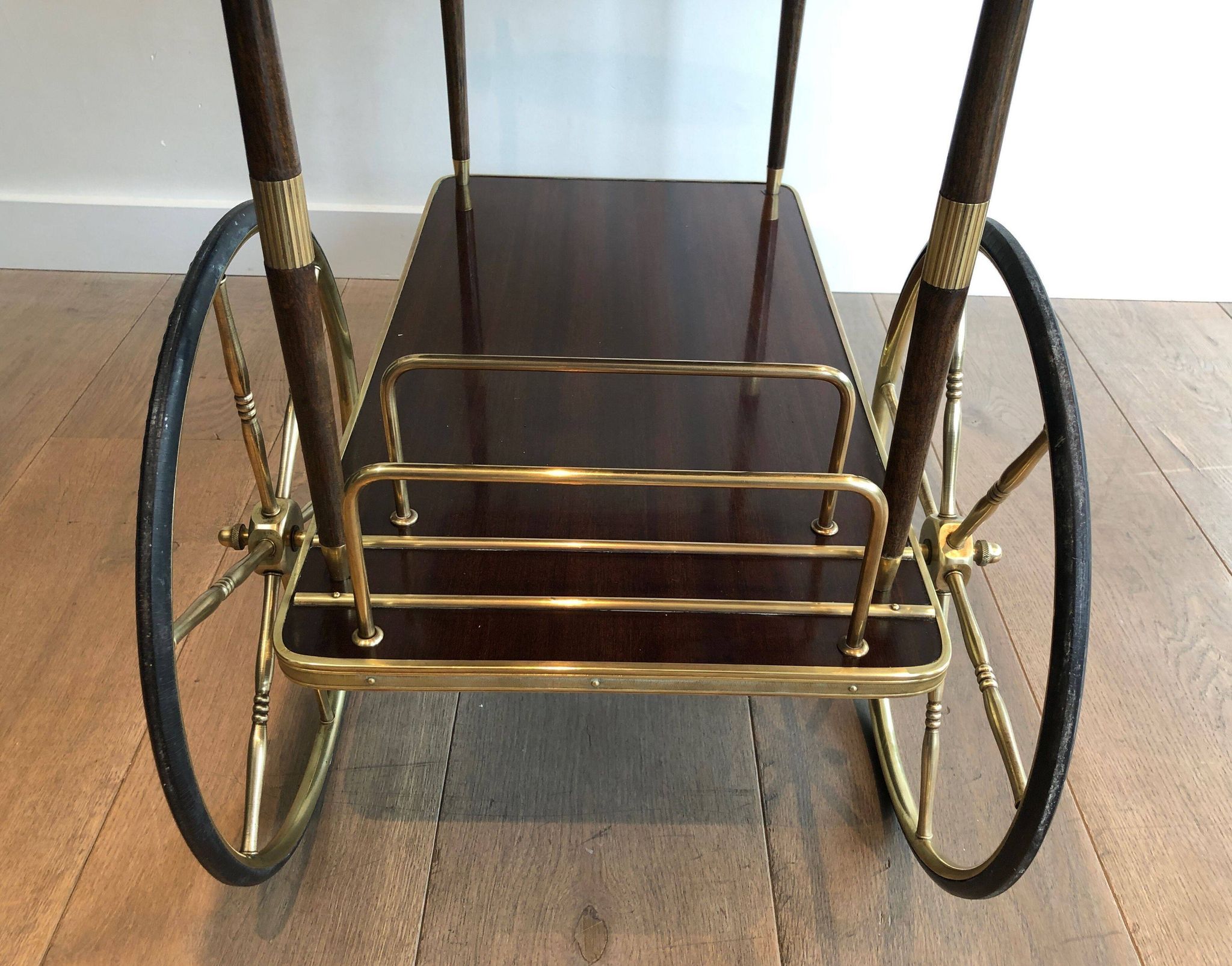 Mahogany and brass rolling table in the style of Maison Jansen.