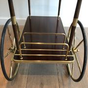 Mahogany and brass rolling table in the style of Maison Jansen.