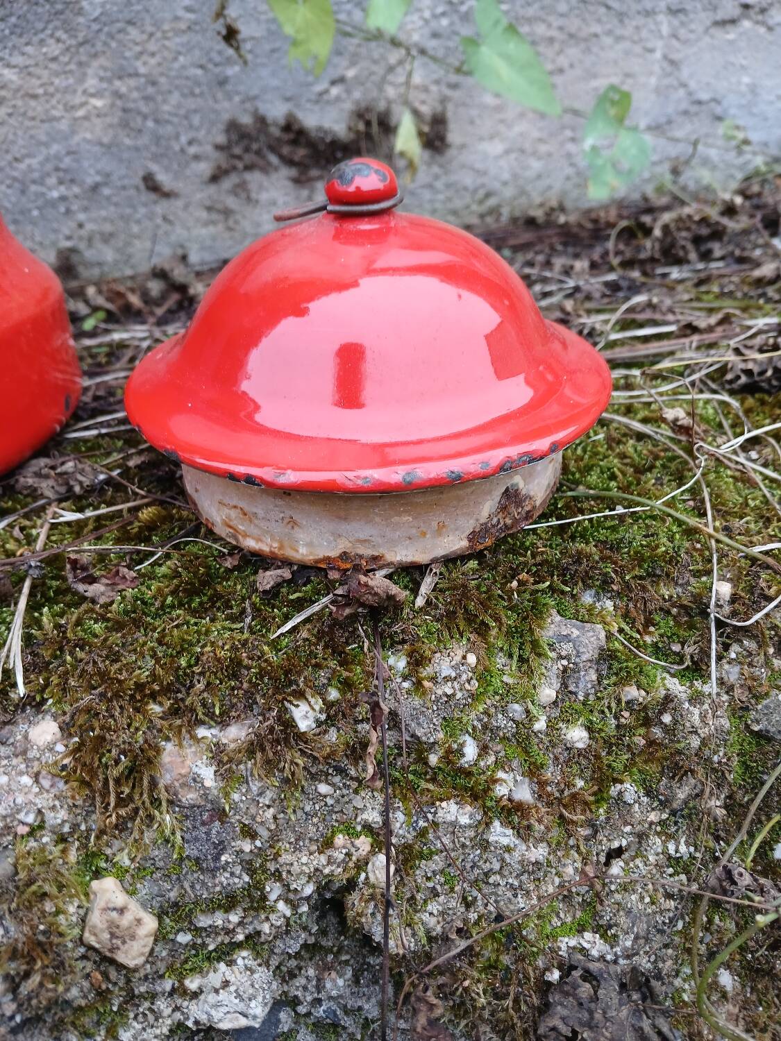 Antique teapot in red enamelled sheet metal