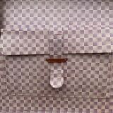 Old large suitcase in leather and tartan fabric