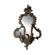 Mirror with a decorative frame featuring a four-light wall sconce, 19th century.