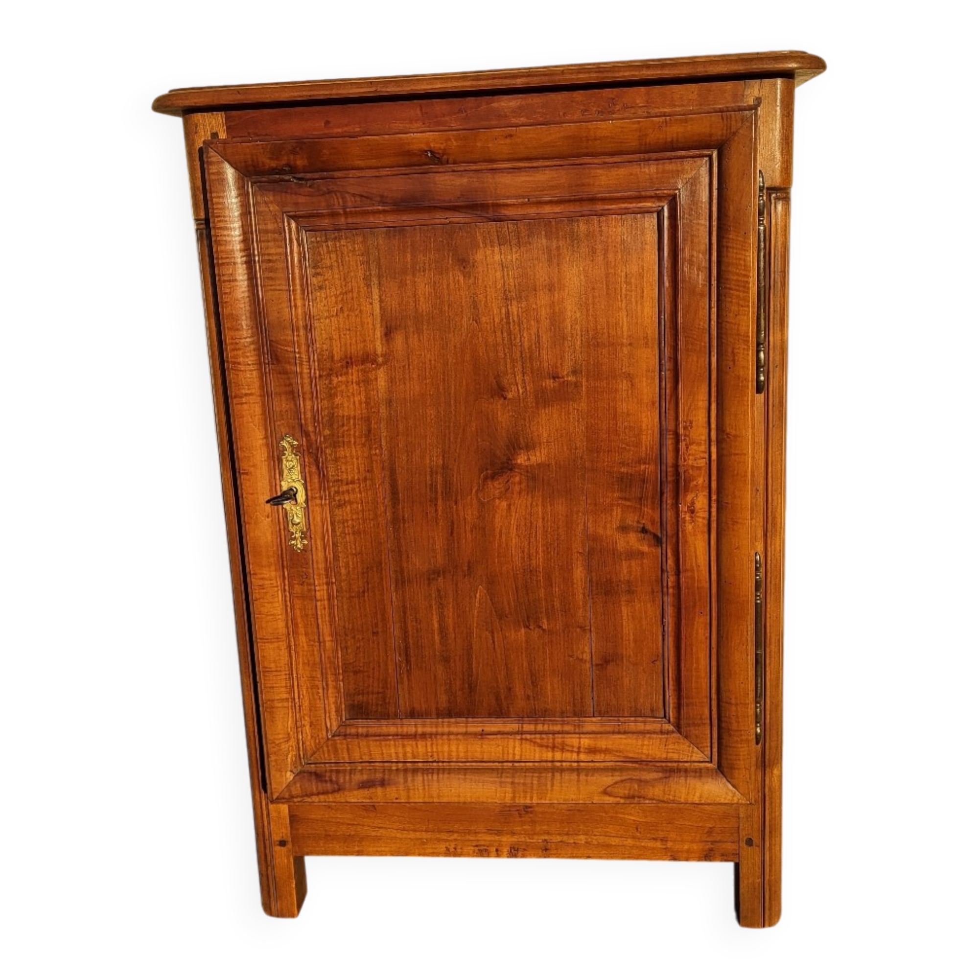 Furniture with a cherry wood door.