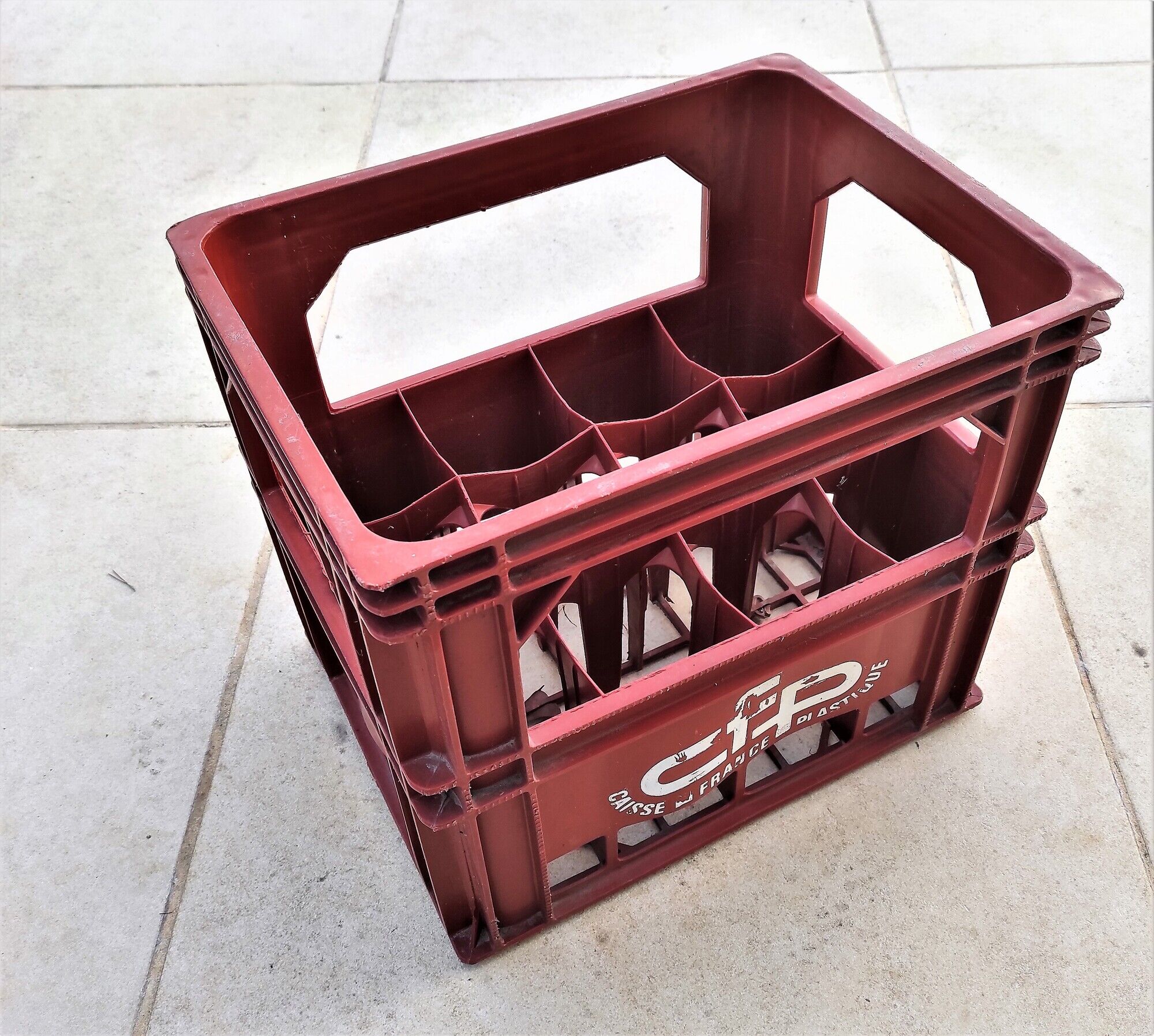 Locker with 12 red plastic bottles of the cfp brand around 1980