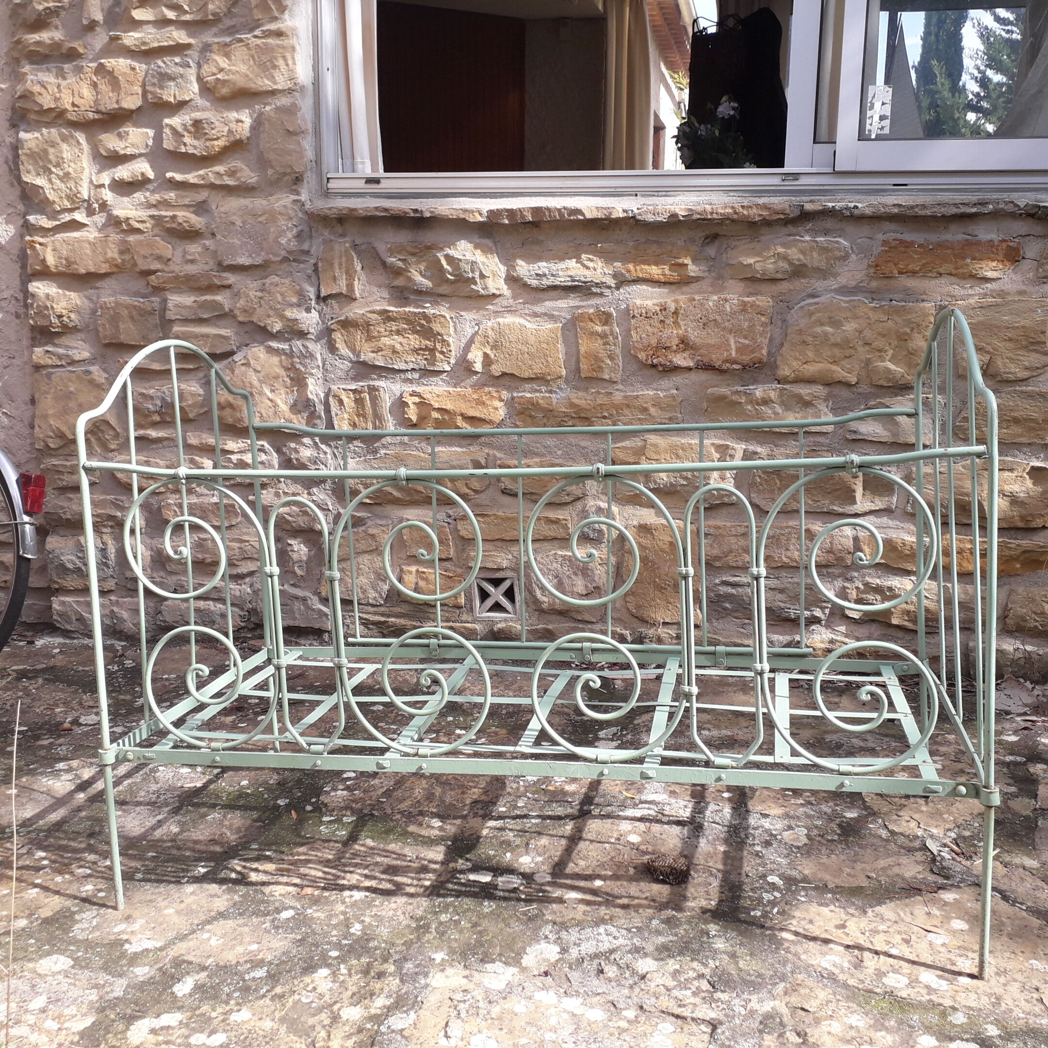 Former child bed in wrought iron