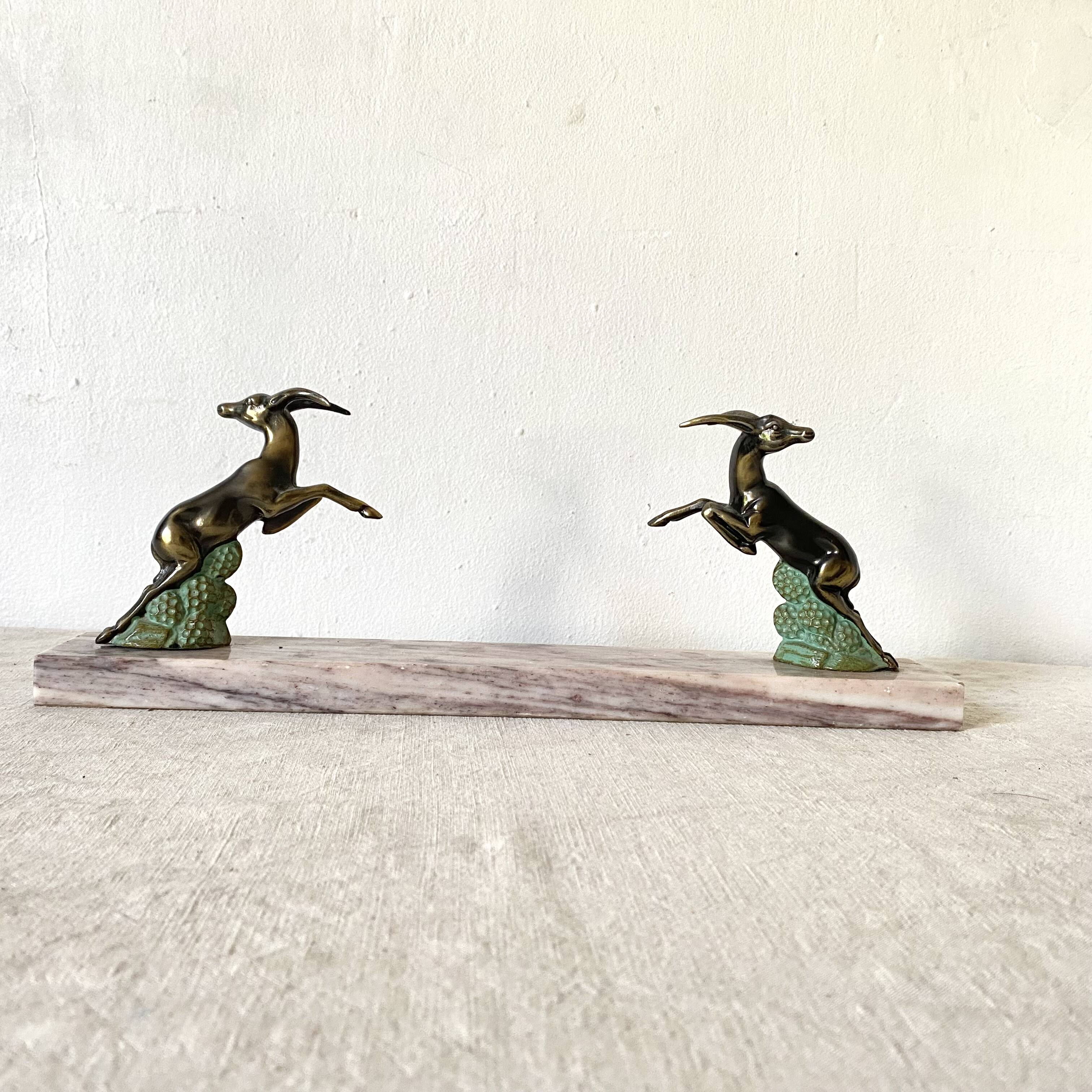 Art deco bookends in pink marble and spelters, antelopes