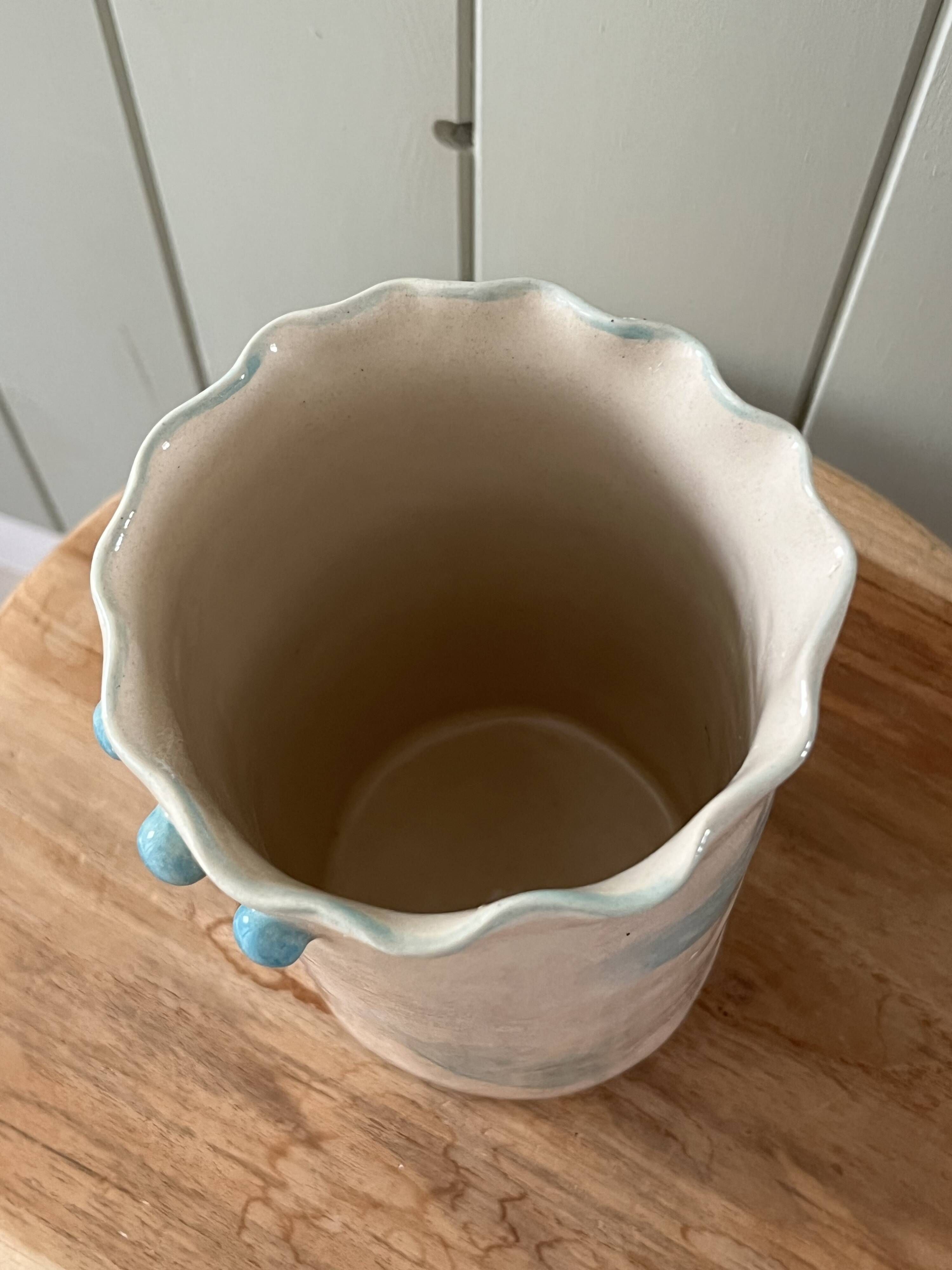 Stoneware vase decorated with flowers in a watercolour style.