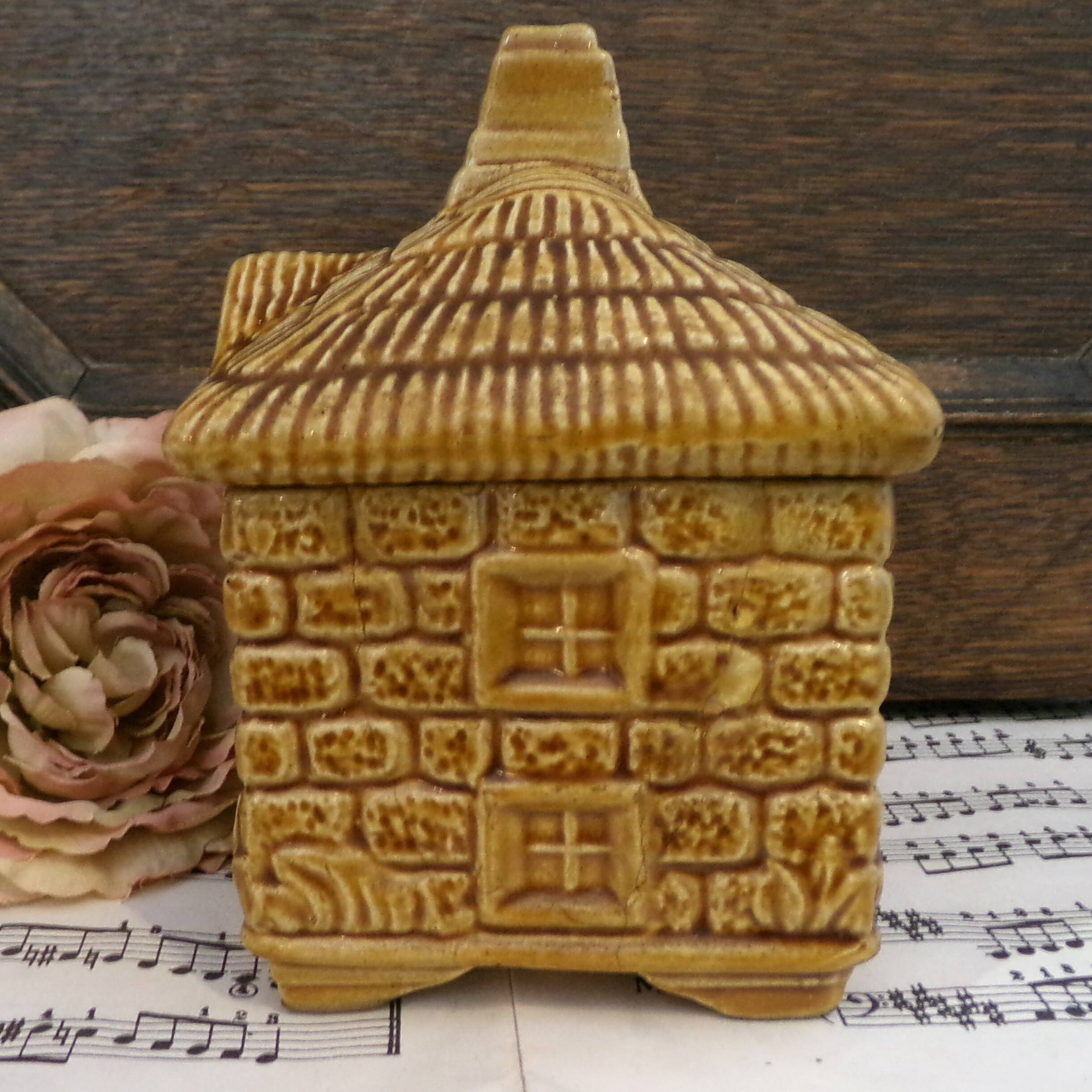 Devonway jam pot in the shape of a cottage with a thatched roof.