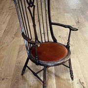 Windsor chair with comb back, stained wood and terracotta velvet.