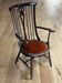 Windsor chair with comb back, stained wood and terracotta velvet.