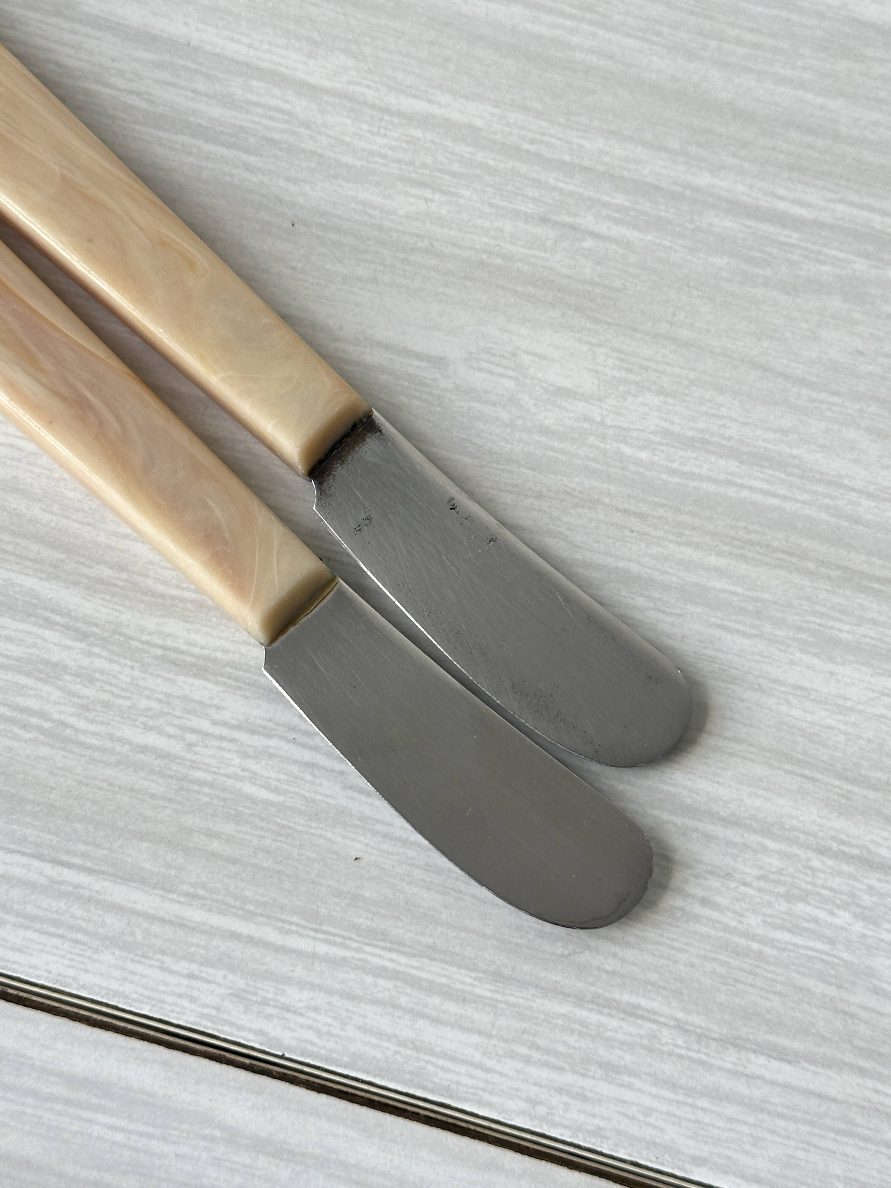Pink bakelite butter knives.