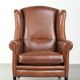 Large sheepskin wingback armchair in timeless English style
