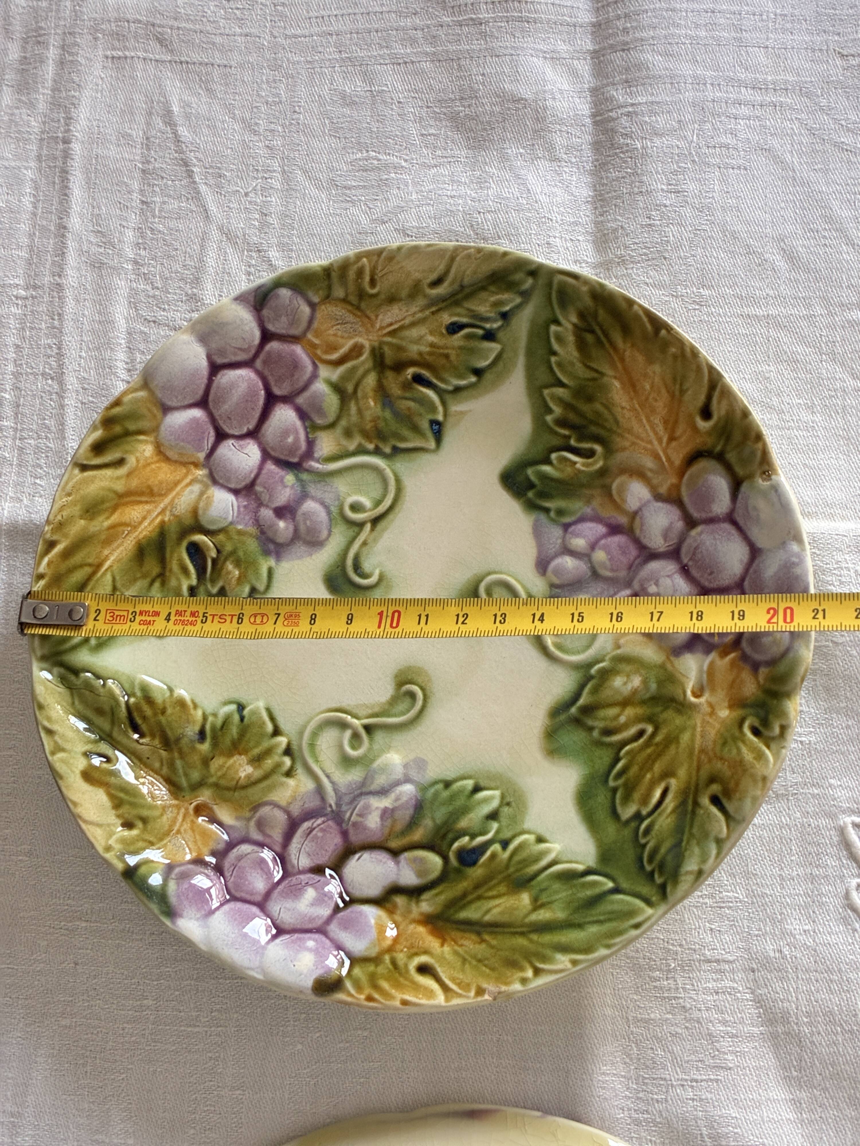 Lot of 4 Onnaing barbotine plates with grapevine design.
