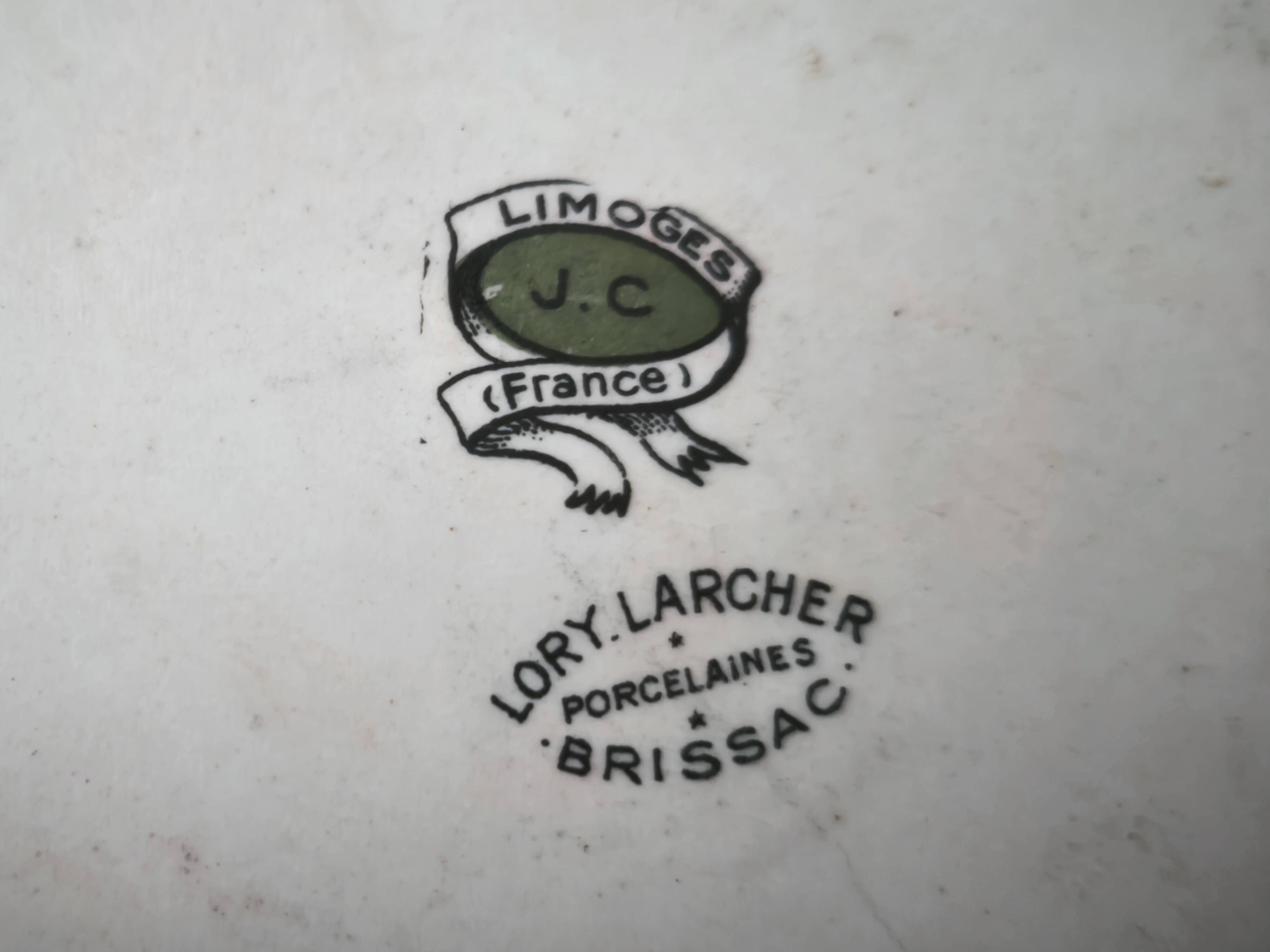 Shallow round plate in Limoges porcelain with a hydrangea basket design.