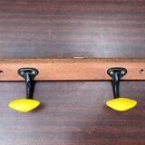 Coat rack with 2 yellow and black hooks