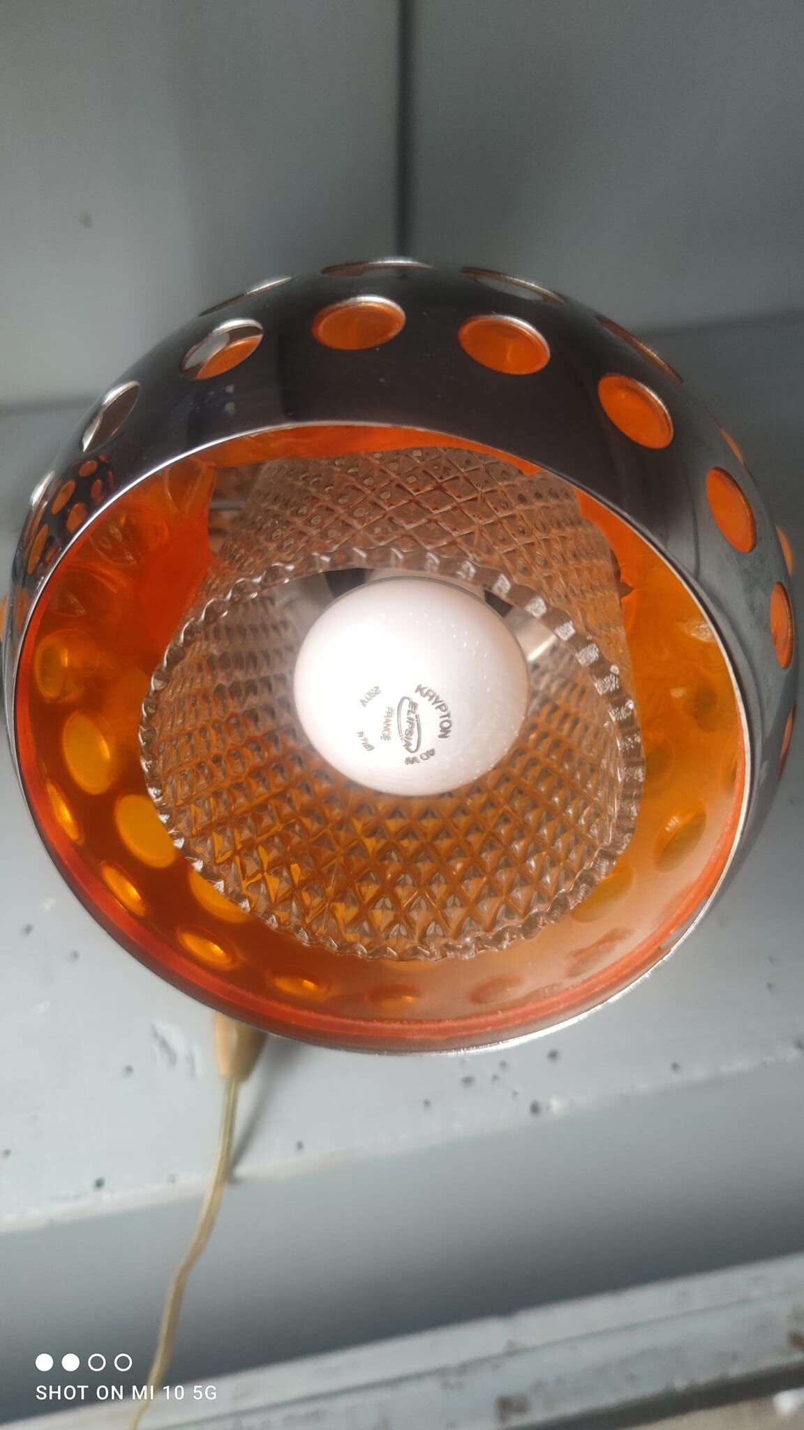 Pair of chrome-plated metal wall lights with adjustable ball joints, circa 1970