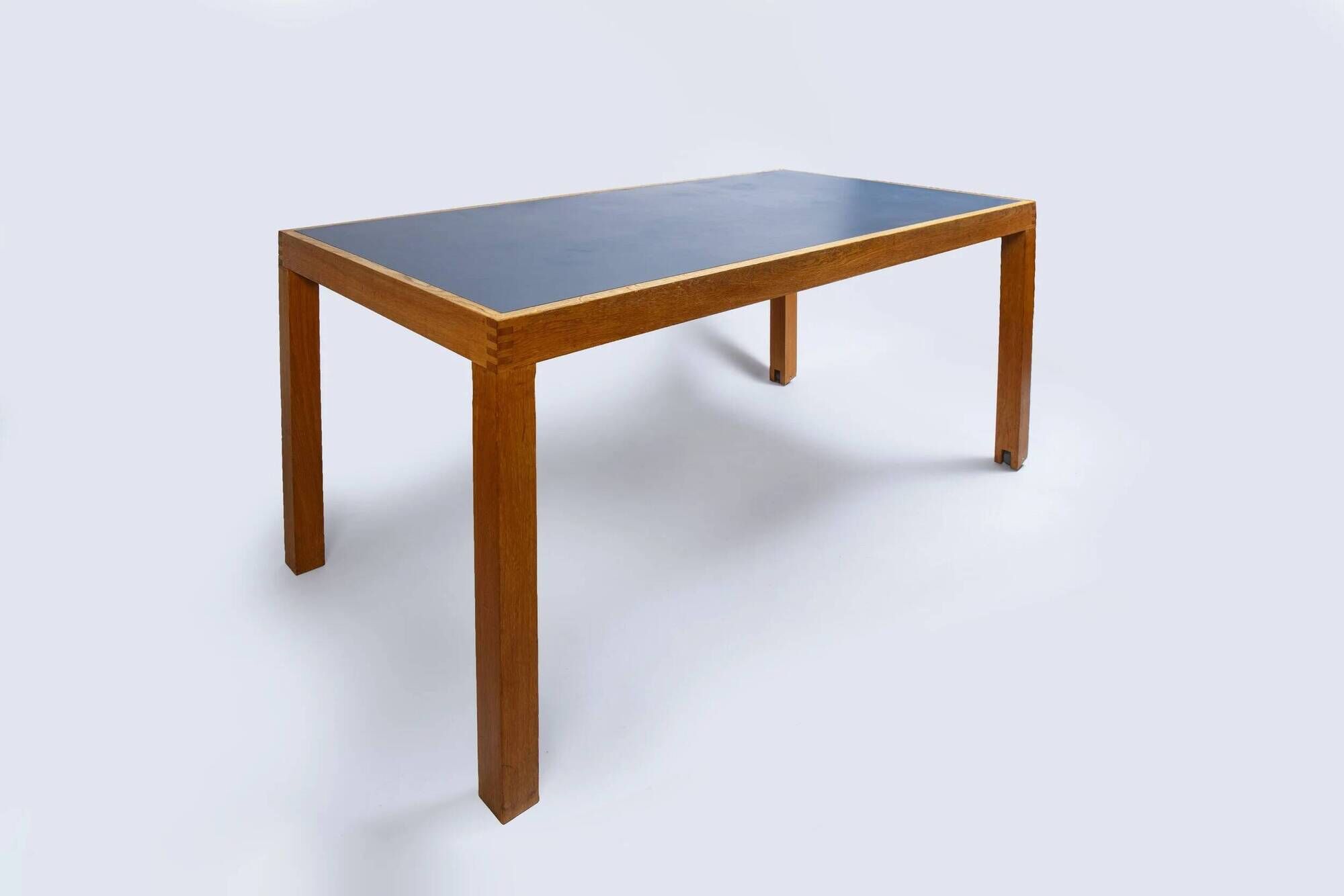 Pine table with a top covered in linoleum.