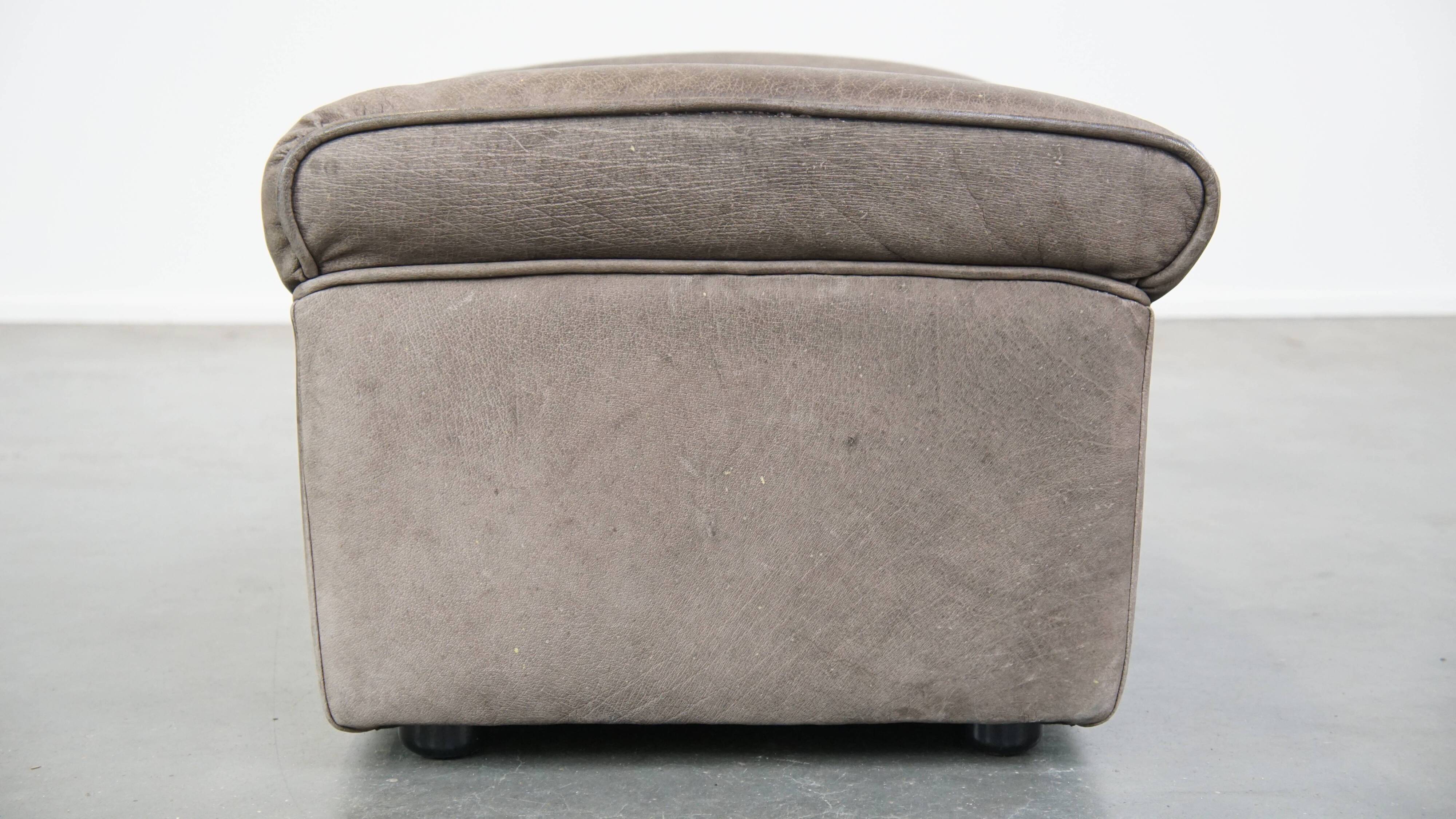 Luxurious, comfortable, gray leather vintage footstool