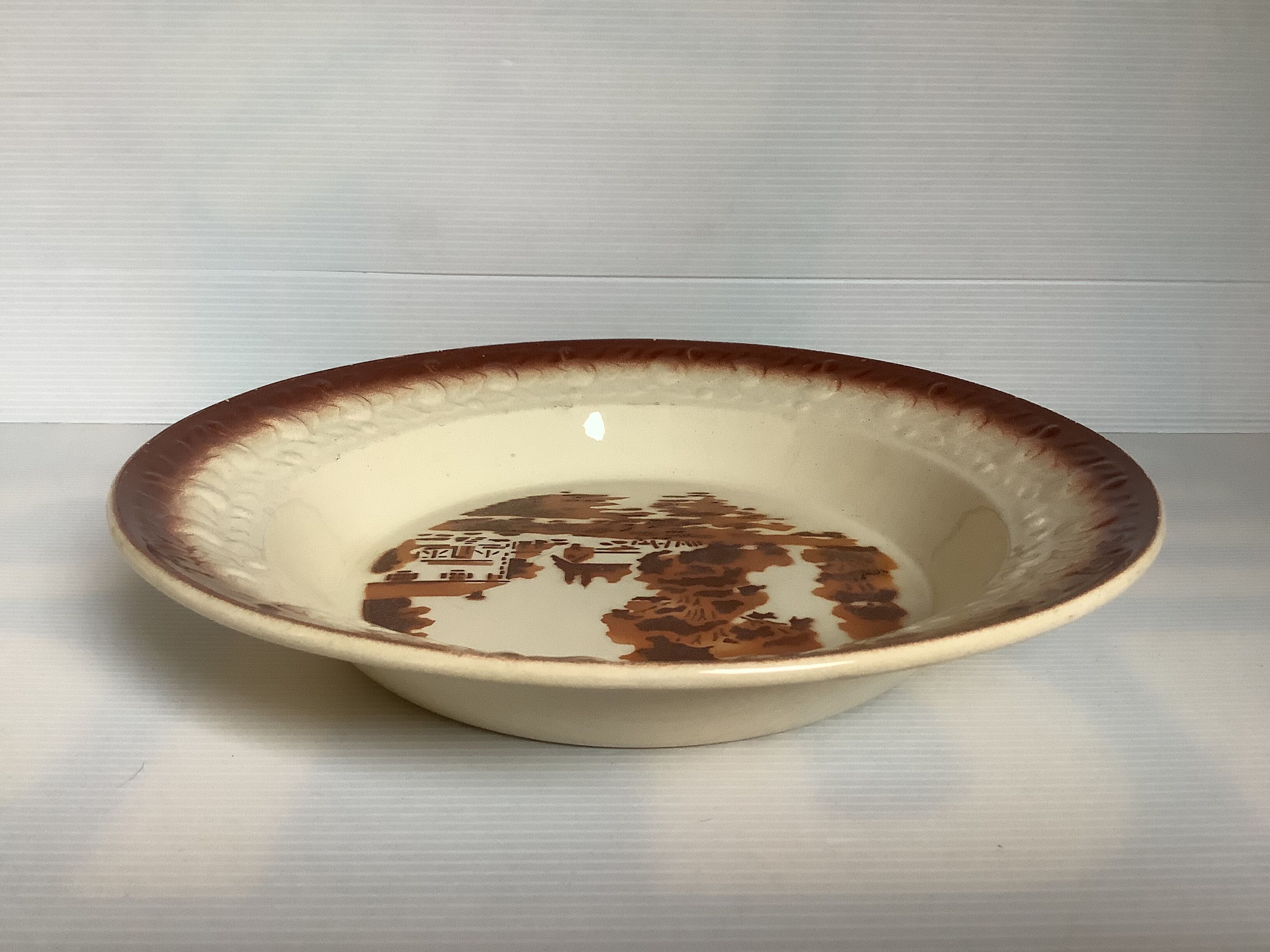 Earthenware plate from Moulin des Loups with stencil pattern.
