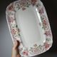 Antique Longchamp serving platter with polychrome daisies in ironstone.