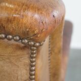 Characteristic antique sheepskin leather armchair with beautiful details and a unique design