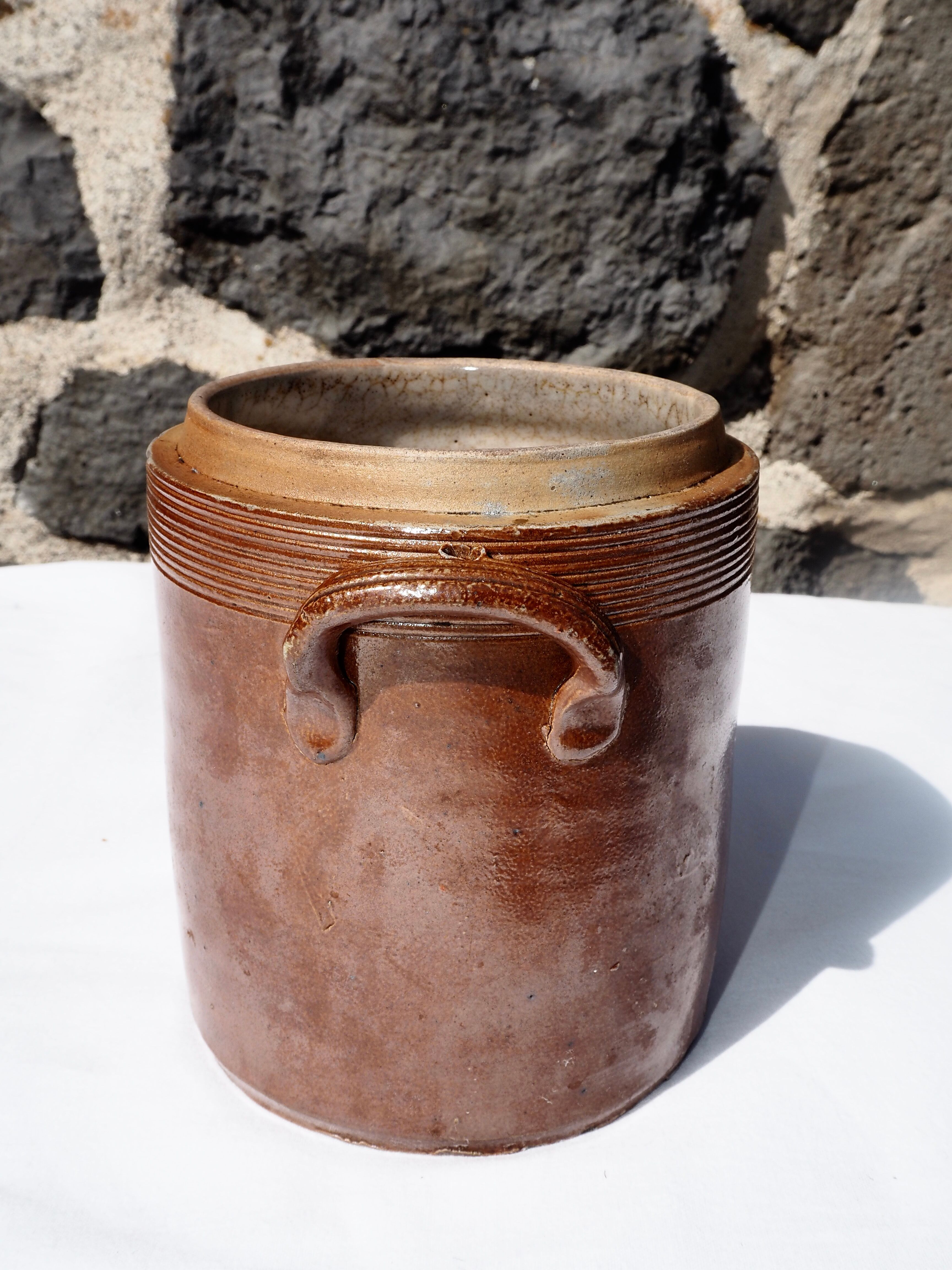 Trio of stoneware pots with lids