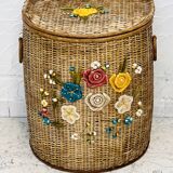 Vintage wicker mannequin with colourful floral decoration.