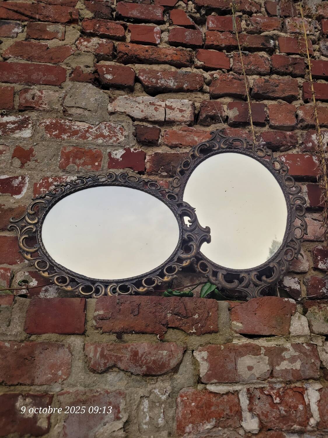 2 antique oval mirrors in heavy metal