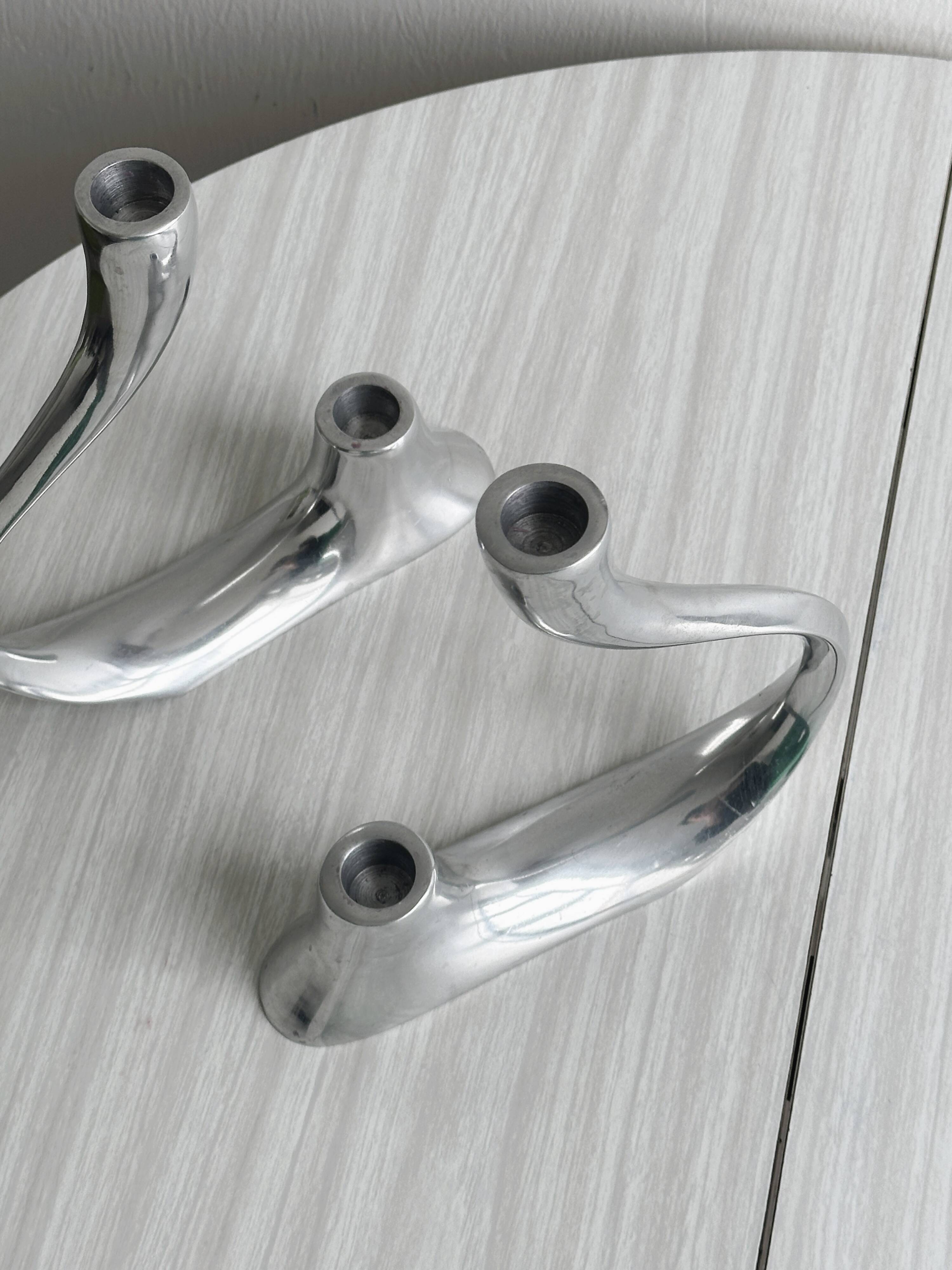 Pair of designer candlesticks in chromed metal