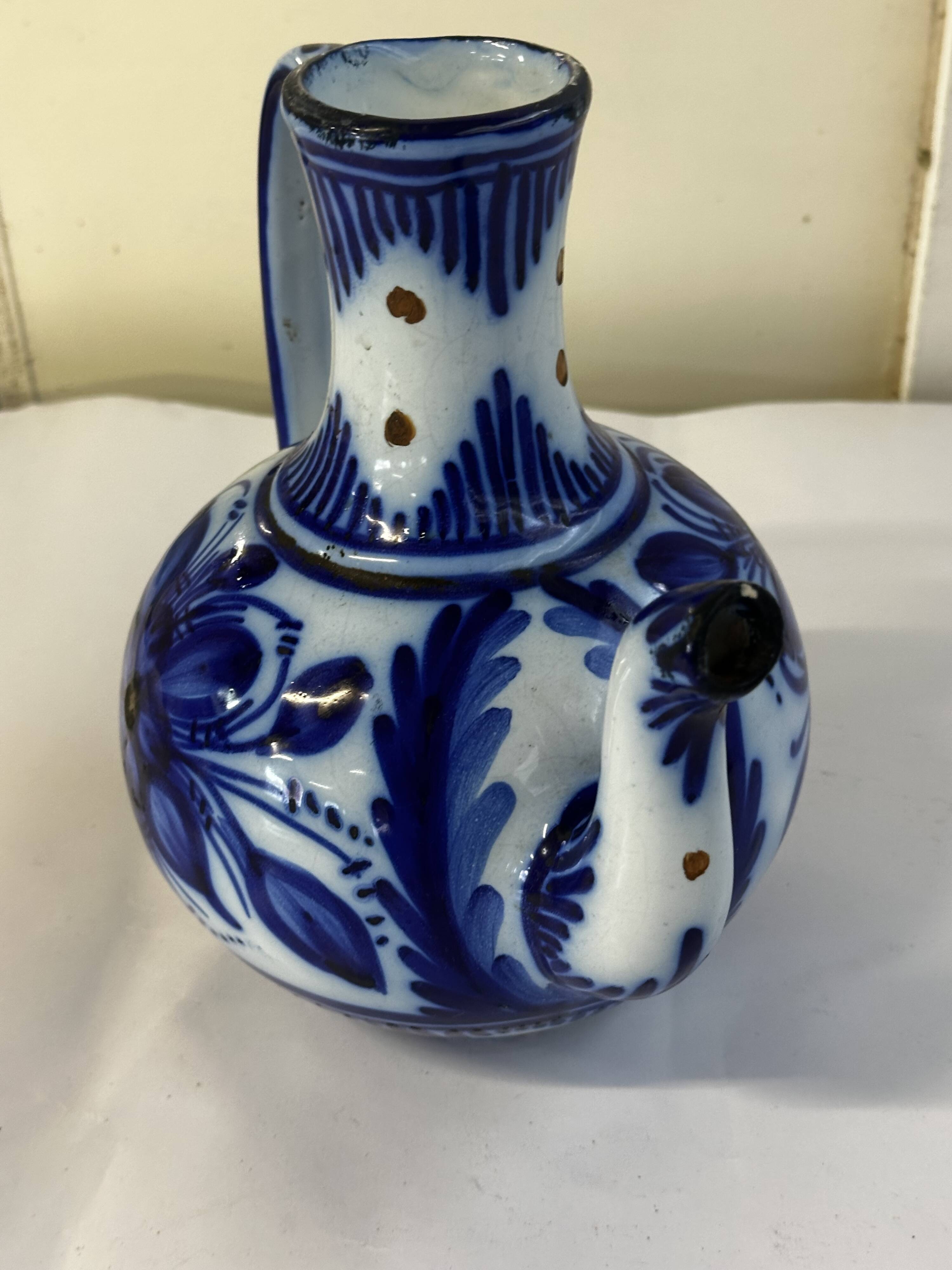 Glazed ceramic carafe with floral decoration