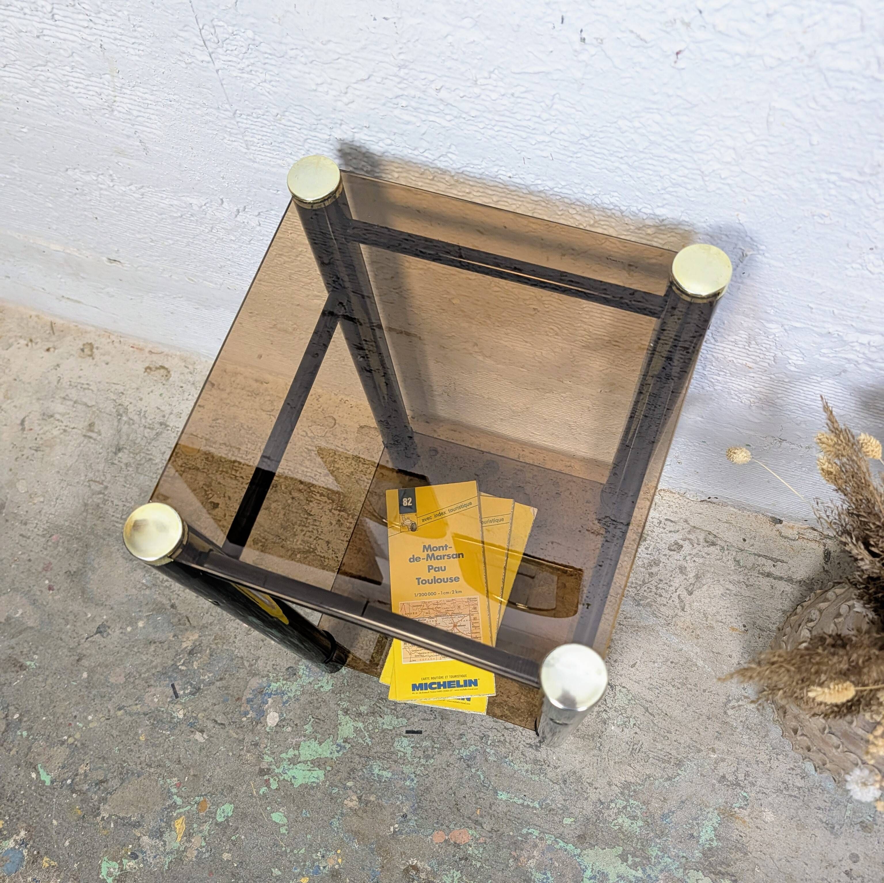 Vintage side table with two smoked glass tops and black metal.