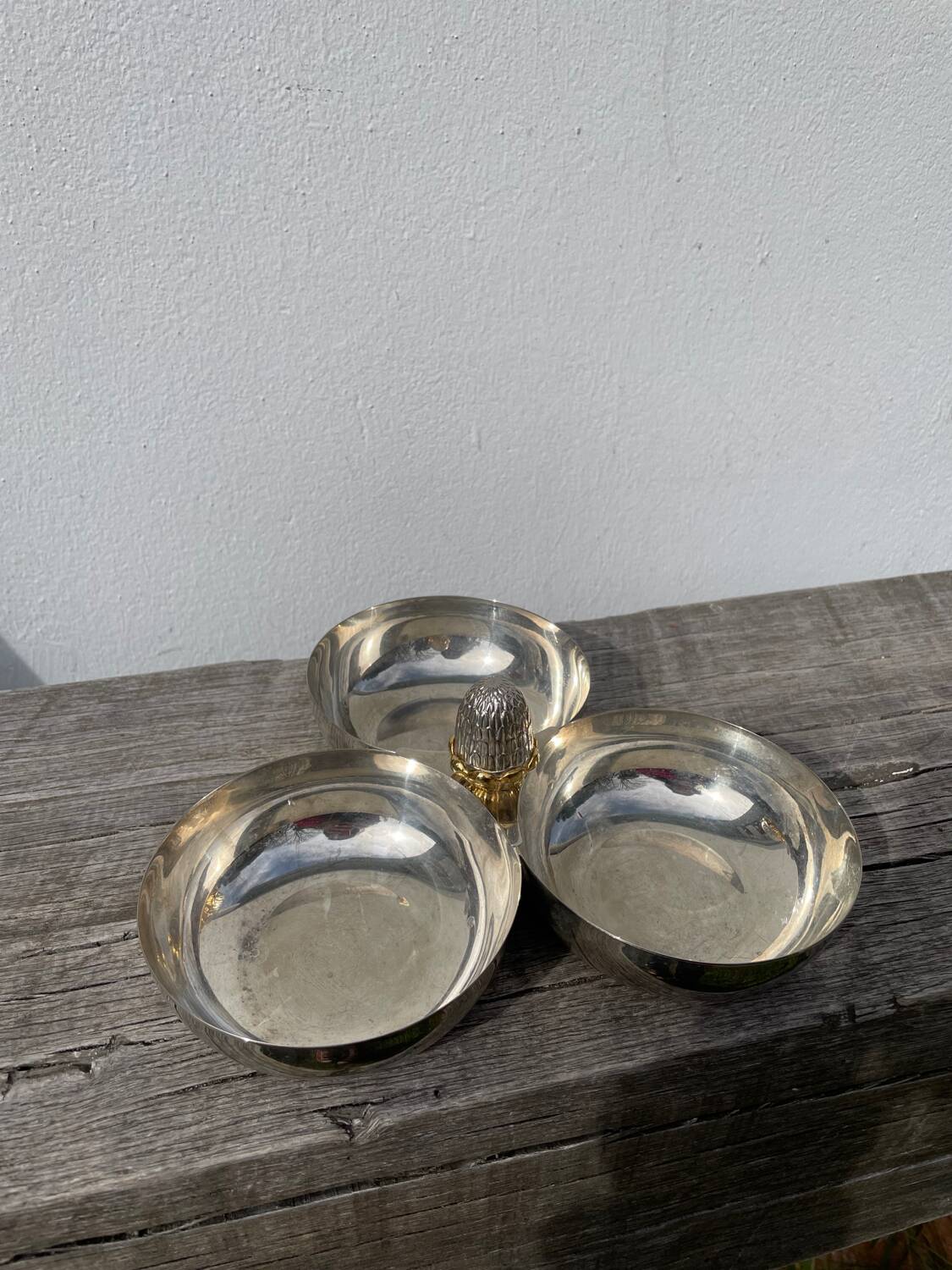 Silver-plated metal dish topped with an acorn