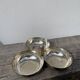 Silver-plated metal dish topped with an acorn