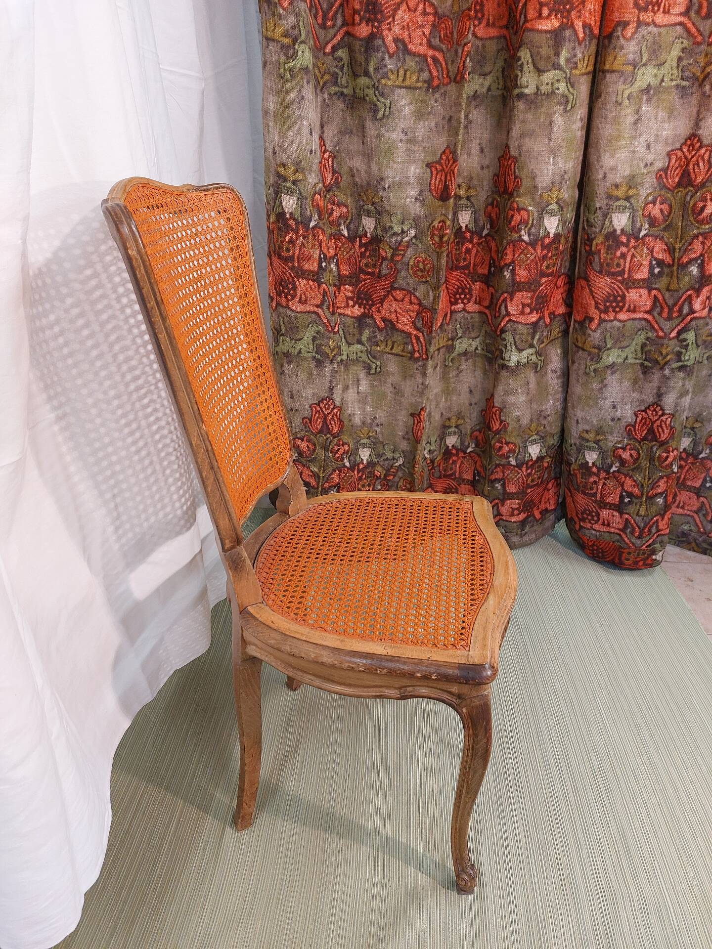 Caned chair in Louis XV style painted orange.