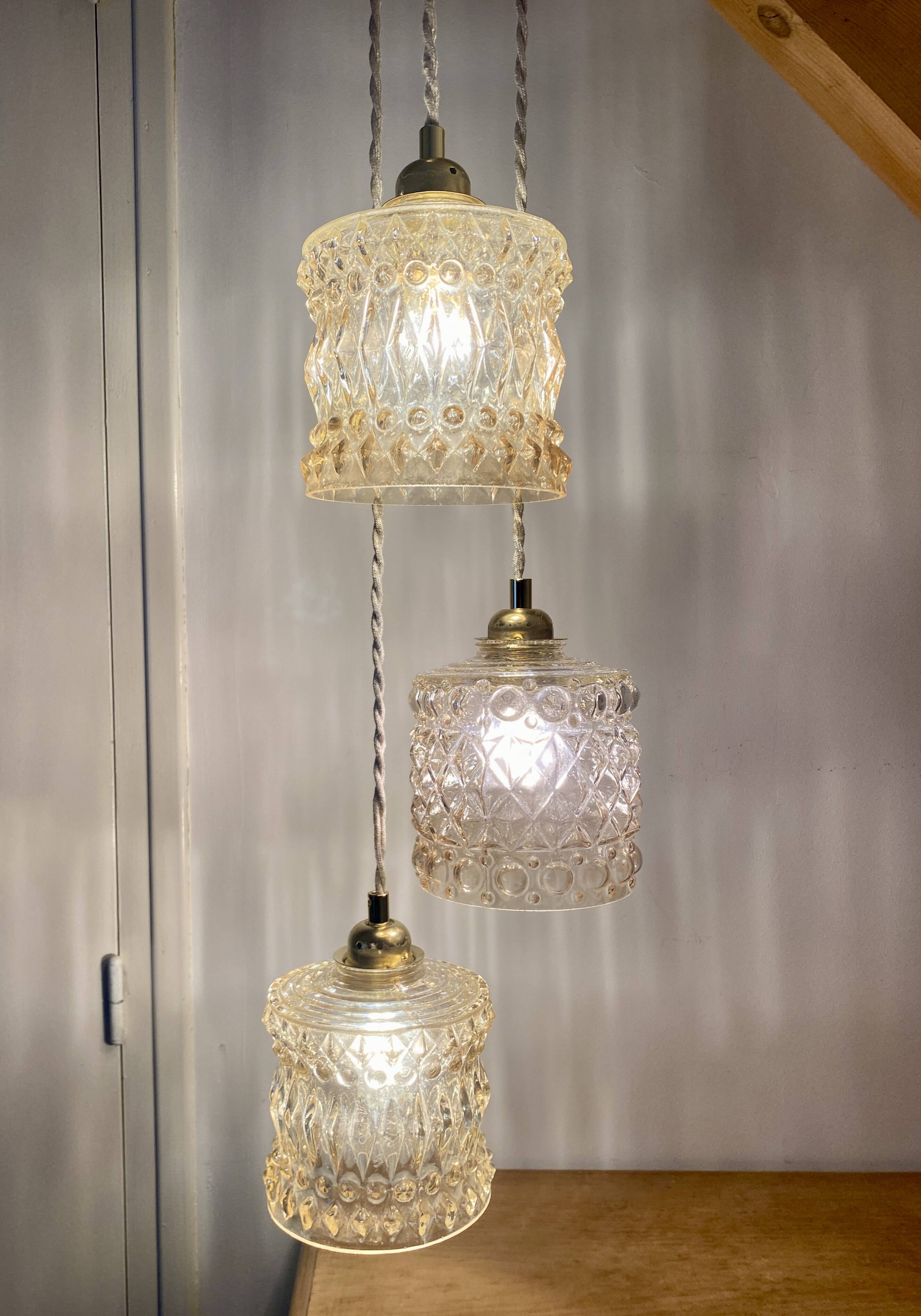 Triple antique globe pendant light in amber glass