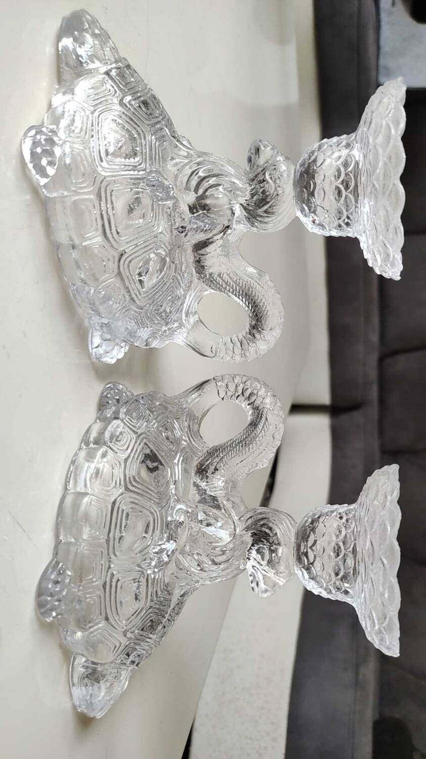 Pair of hand candlesticks/glassware from Portieux/Vallerysthal. In molded glass. Zoomorphic form of turtle carrying a griffin on its back.