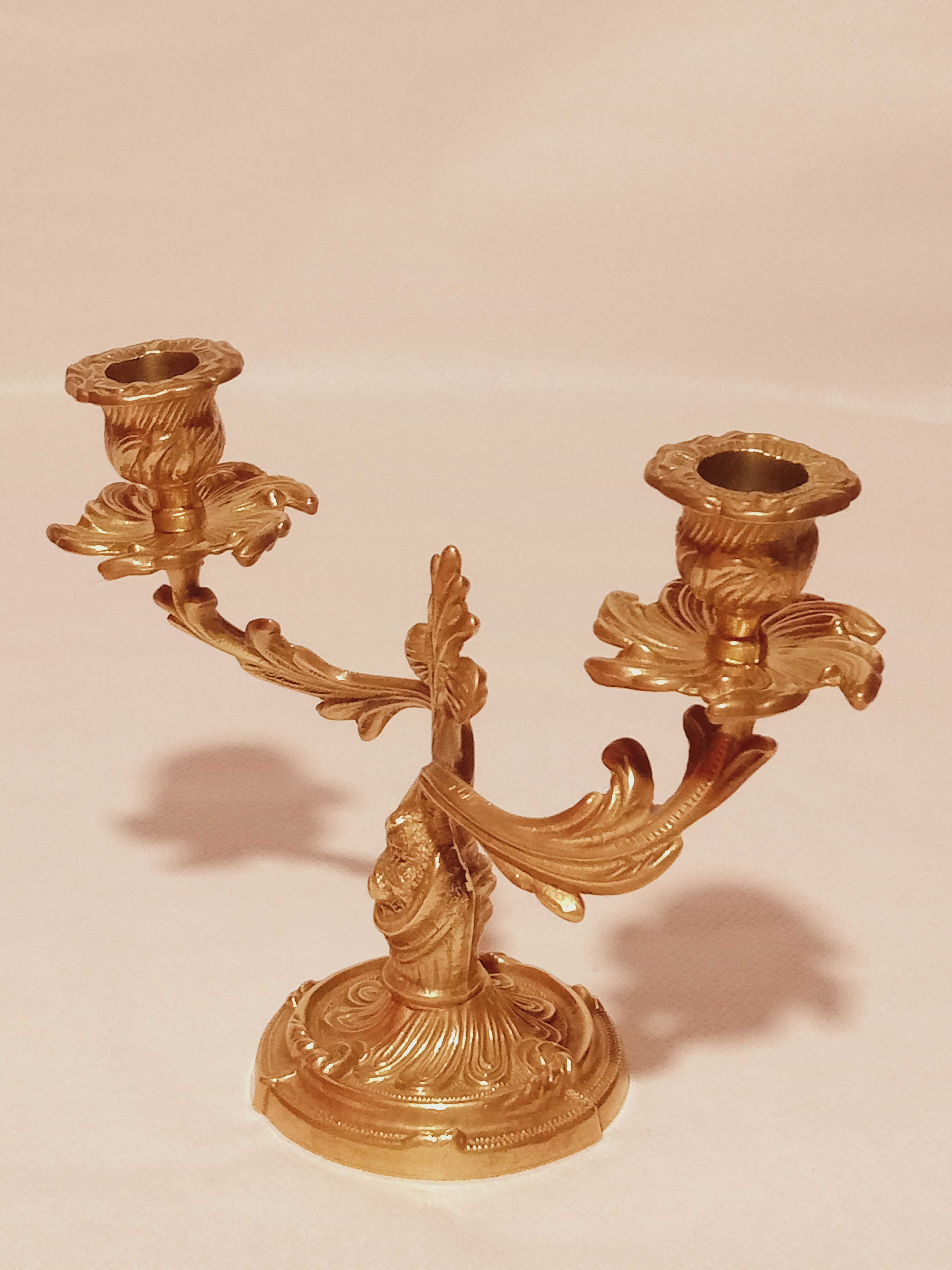 Old candle holder in gilded bronze