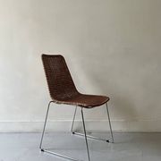 Chair design in rattan, woven wicker and chrome wire metal.