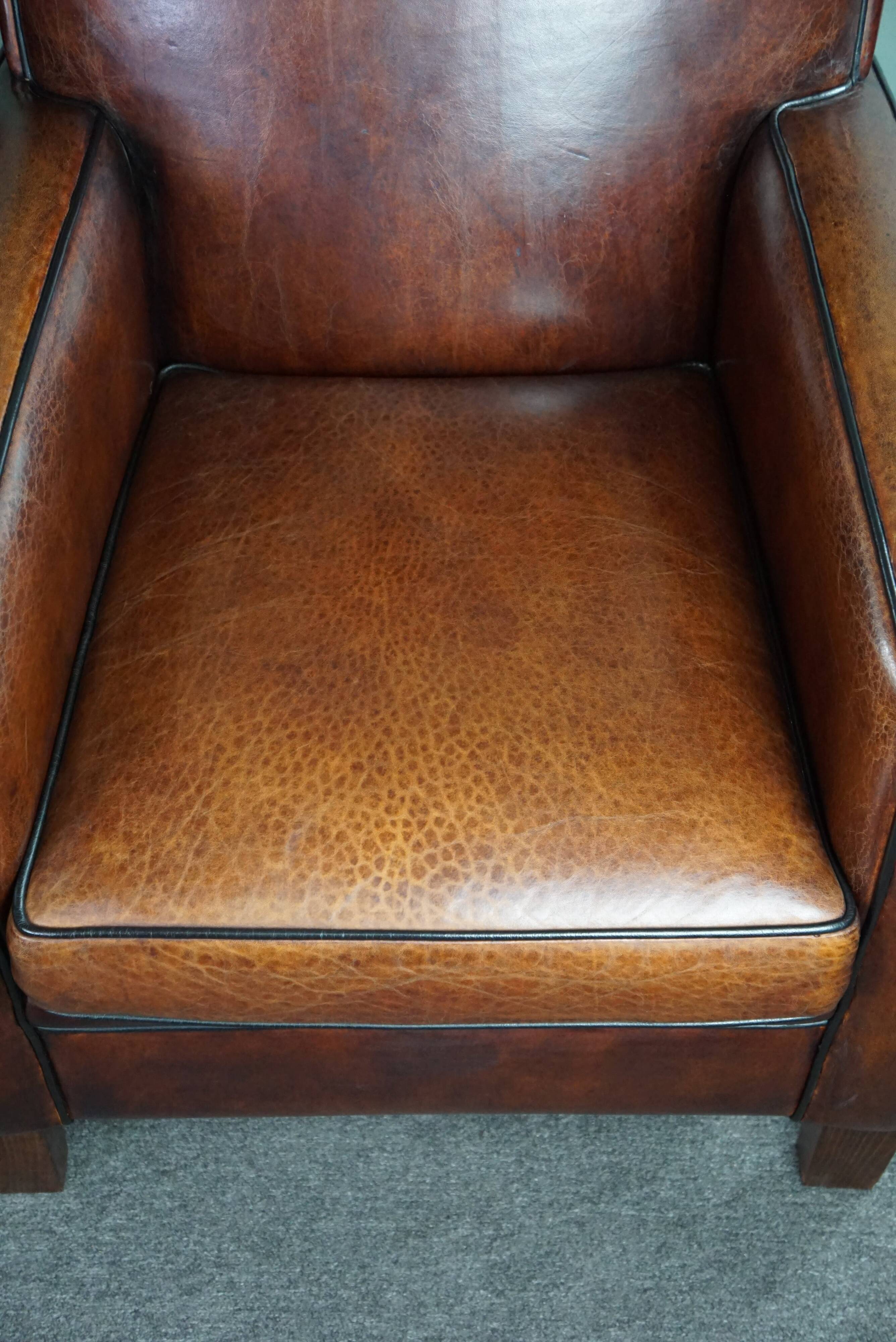 A very beautiful set of 2 Art Deco design armchairs in sheep leather