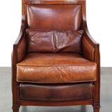 Comfortable Art Deco design armchair in cognac-colored sheepskin combined with wood