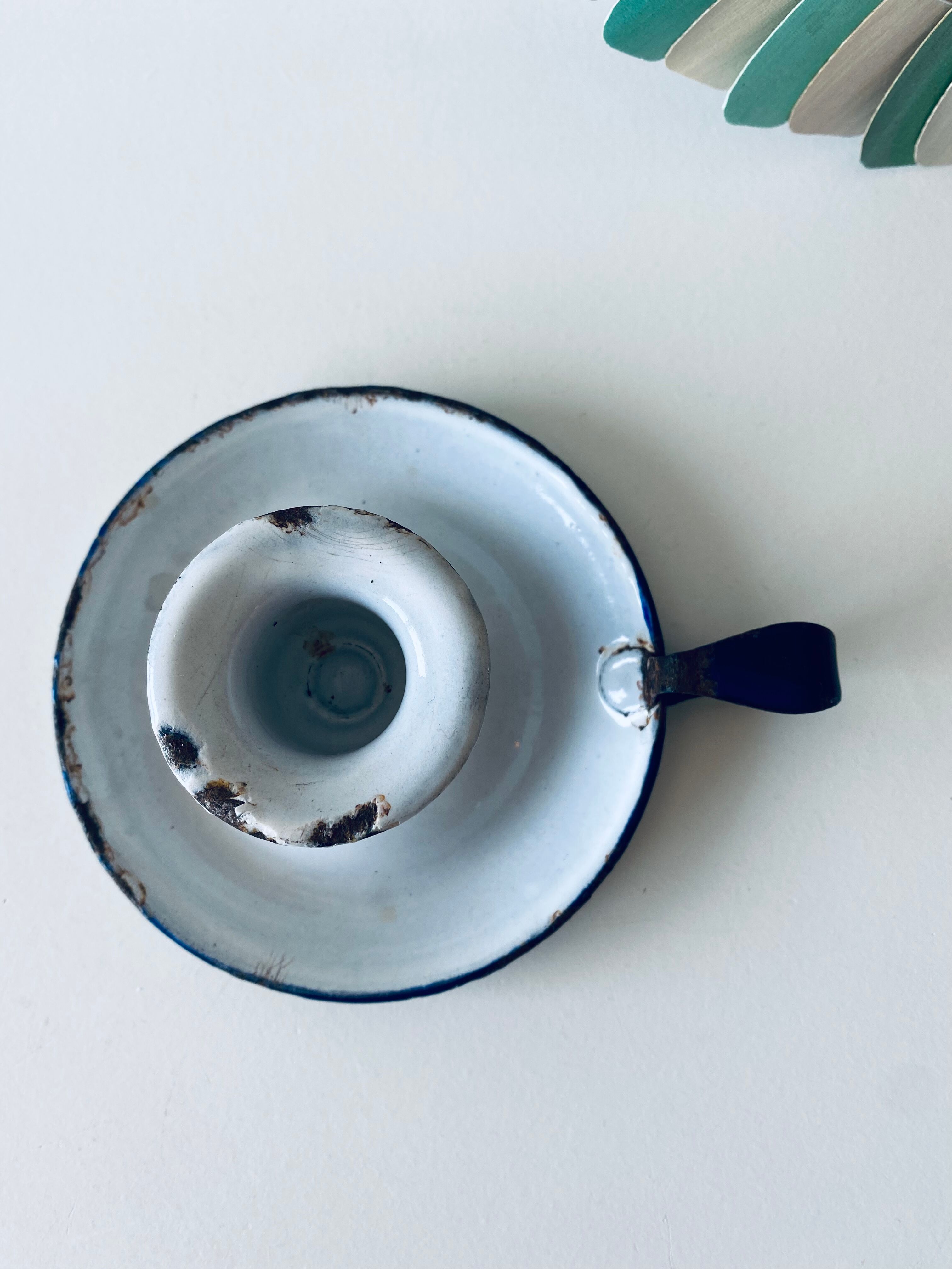 Antique candle holder in white and blue enamelled metal