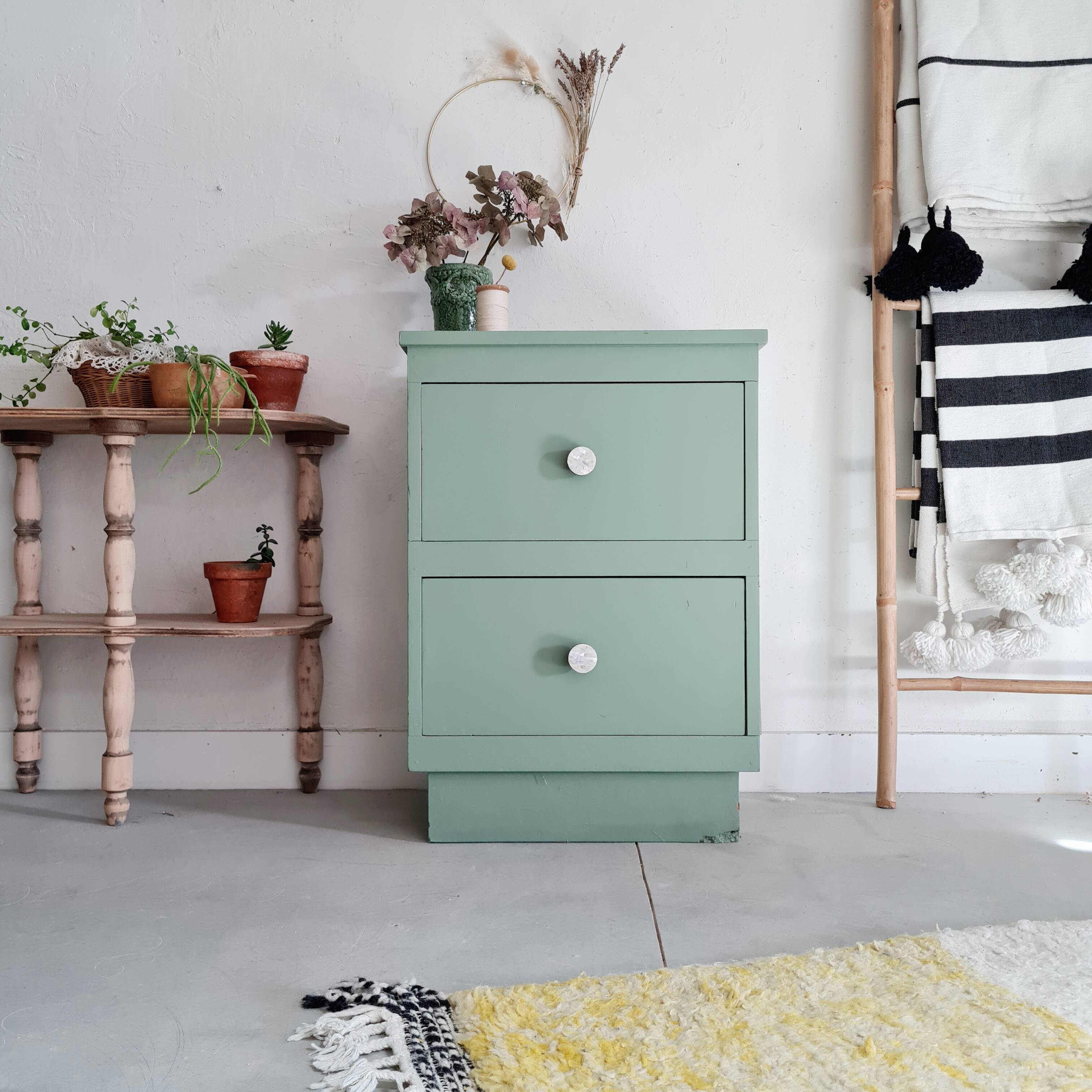 Old chest of drawers with two green drawers