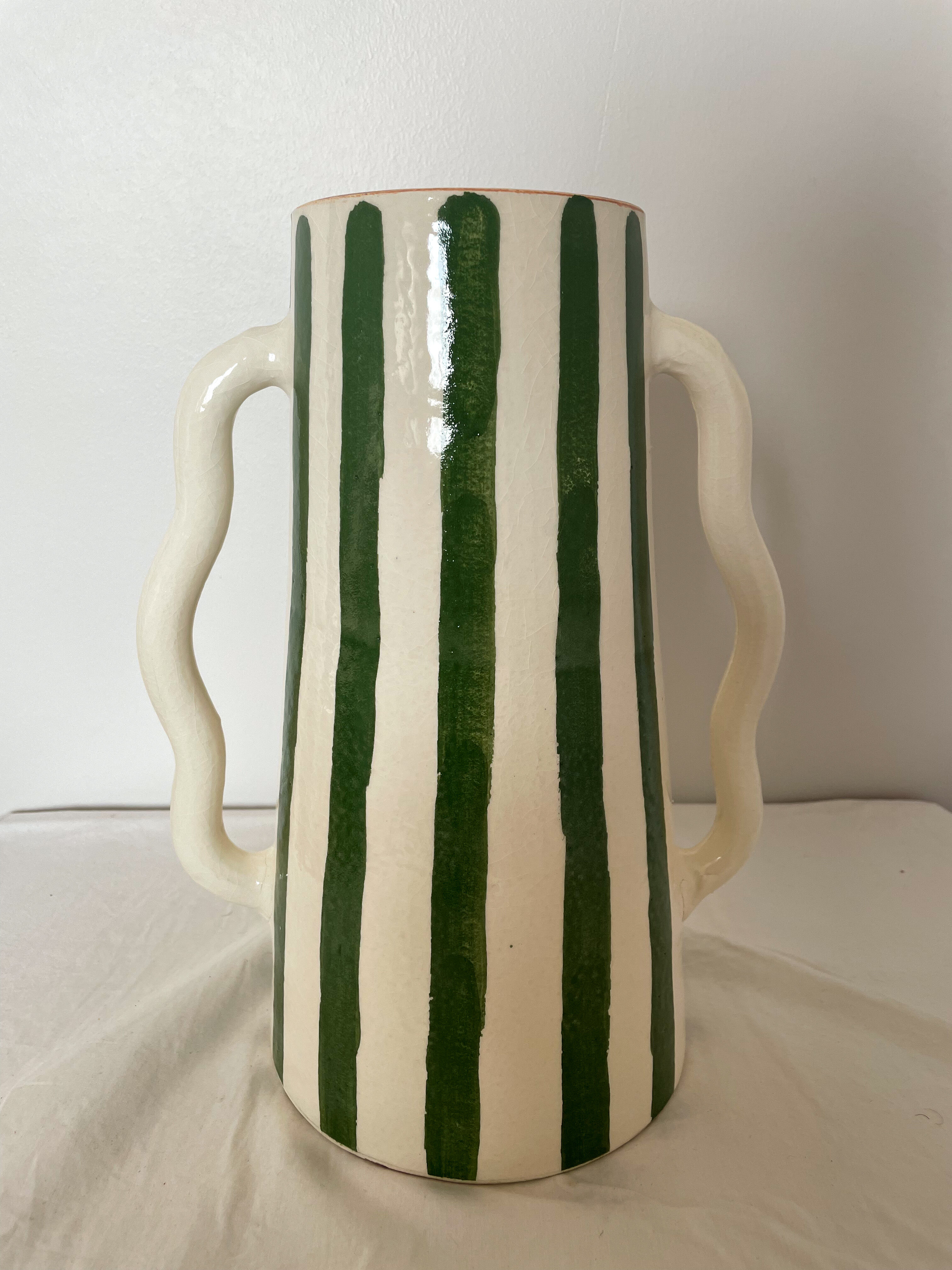 Handmade green and white striped ceramic vase with abstract corrugated handheld