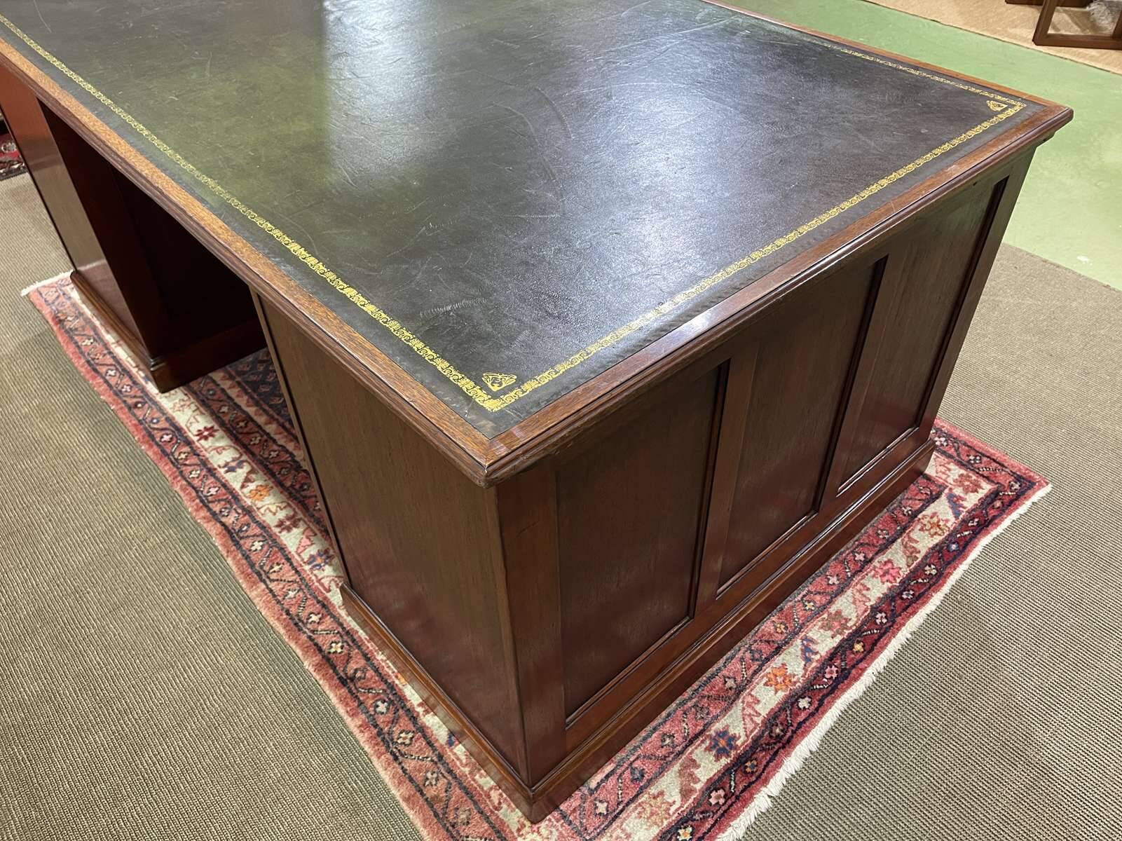 Large English flat desk in mahogany with leather top, early 20th century