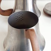 Letang and Remy tea and coffee service in plain stainless steel, exotic wood handles and lids.