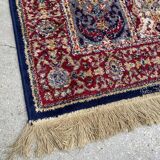 Vintage mechanical Turkish rug with box decoration on a red and navy blue background 139 x 68 cm