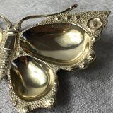 Butterfly-shaped brass pocket emptier